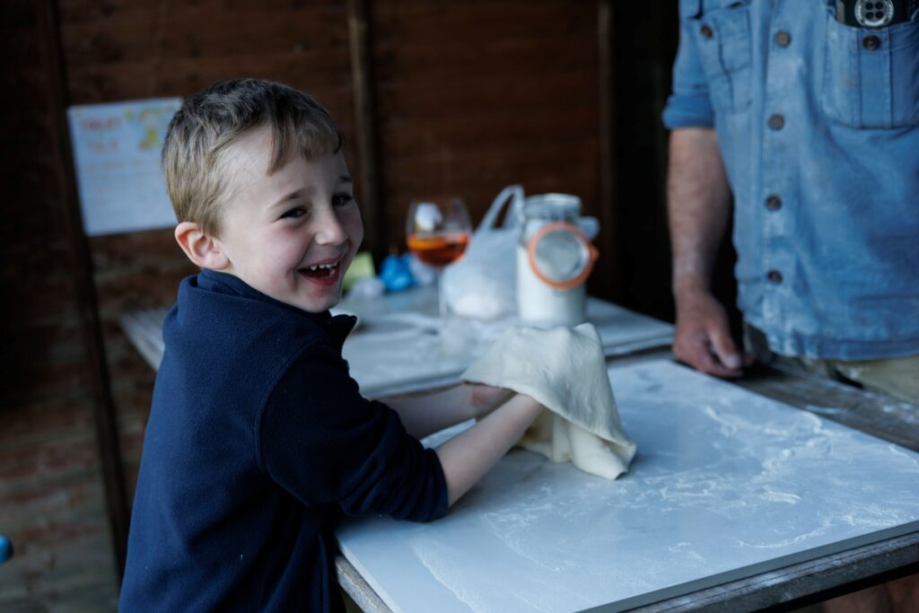 Child making pizza at Pure Space glamping, Loop Head Peninsula, County Clare, Ireland