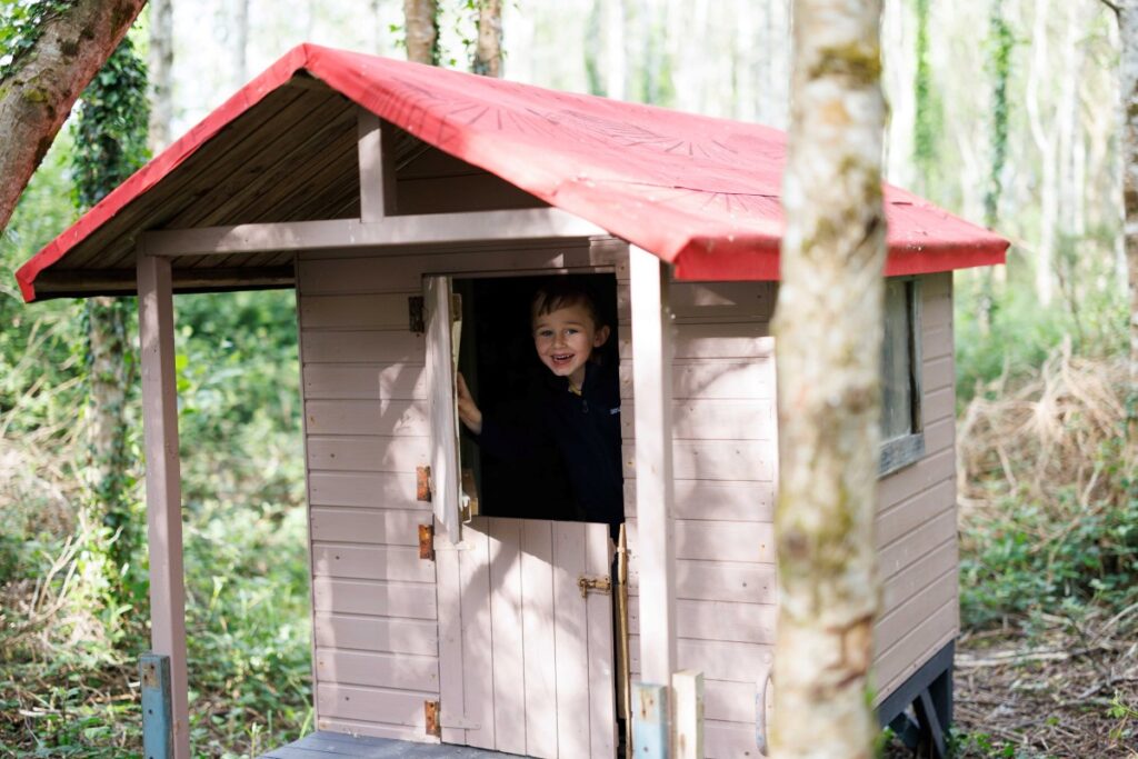 Child in a tree house in the woods at Pure Space glamping, Loop Head Peninsula, County Clare, Ireland
